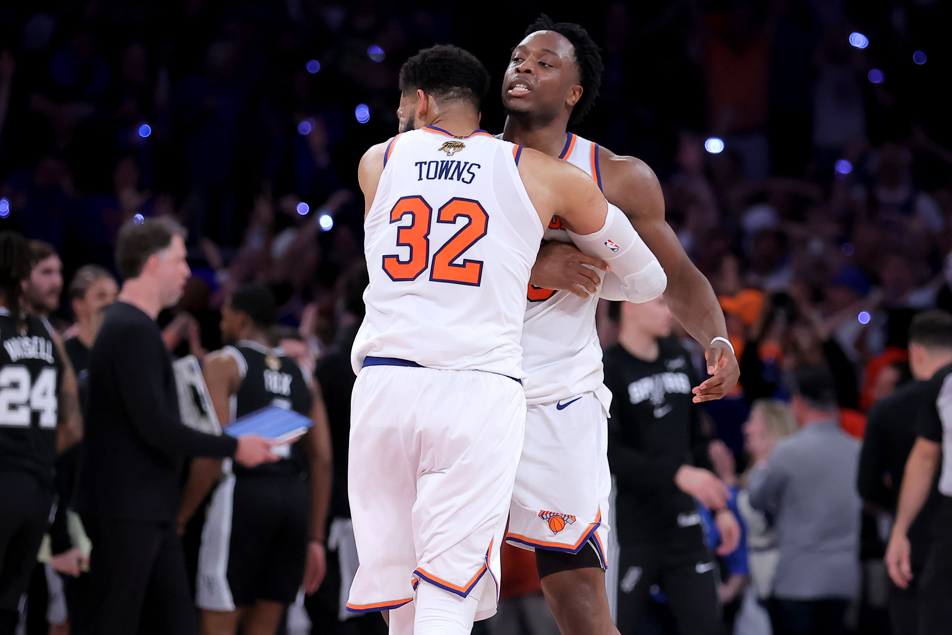 New York Knicks center Karl-Anthony Towns (32) hugs forward OG Anunoby (8) after Anunoby's go ahead basket as we break down our Knicks vs. Spurs prediction.