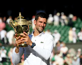 Novak Djokovic celebrates victory by holding the trophy during Day 14 of The Championships Wimbledon 2022 at All England Lawn Tennis and Croquet Club on July 10, 2022 in London, England. 