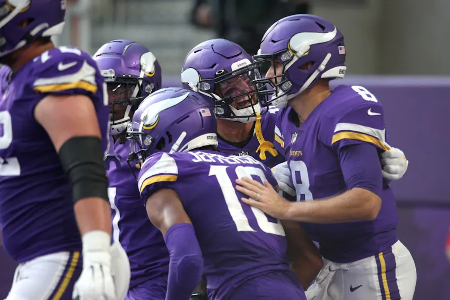 Adam Thielen of the Minnesota Vikings celebrates with Kirk Cousins after throwing a touchdown to Justin Jefferson during the second quarter in the game against the Seattle Seahawks at U.S. Bank Stadium.