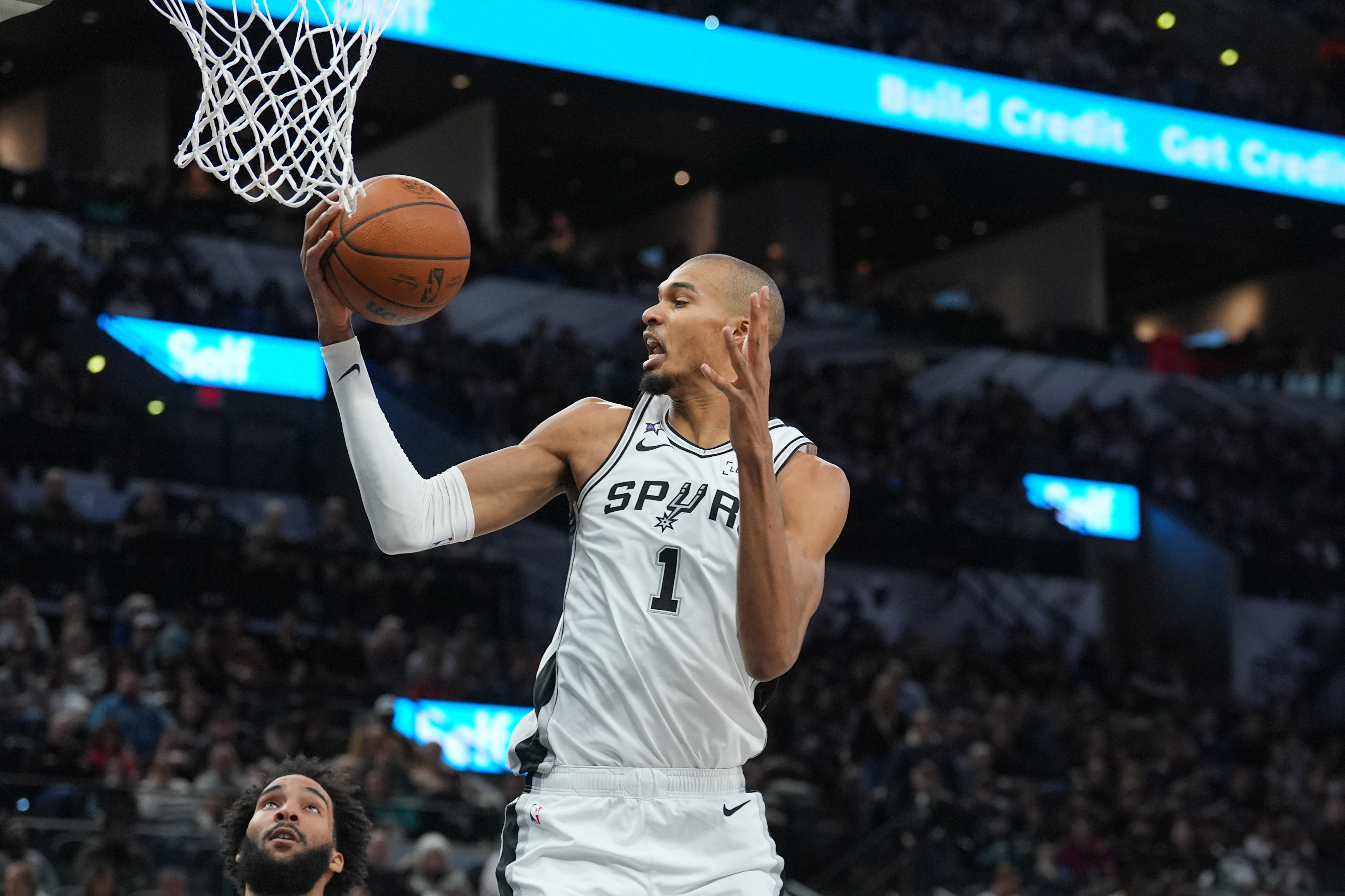 San Antonio Spurs forward Victor Wembanyama (1), seen here rebounding, is featured in our NBA player props and best bets today.