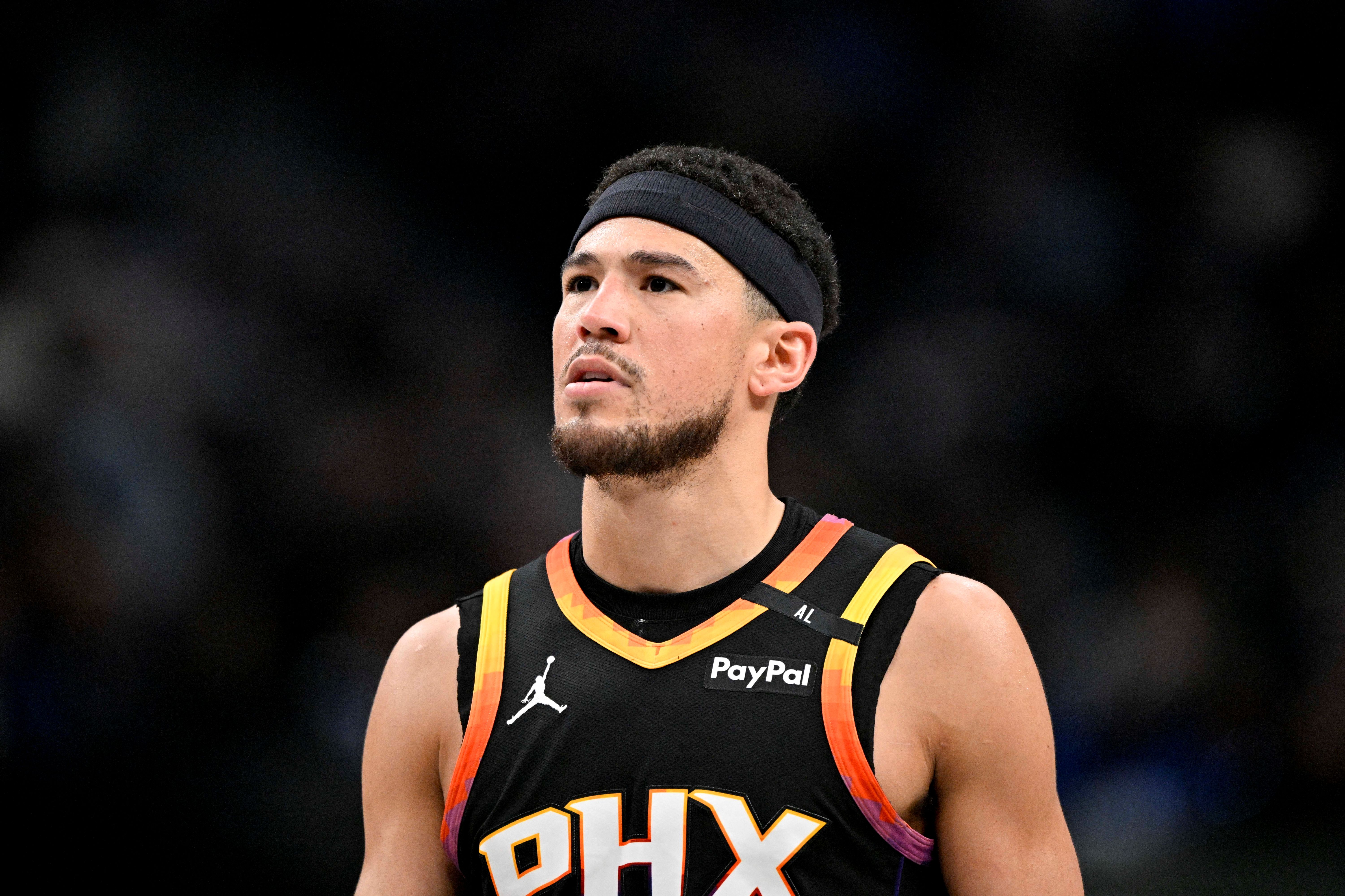 Phoenix Suns guard Devin Booker (1) looks on as we break down the NBA Play-in Tournament odds.