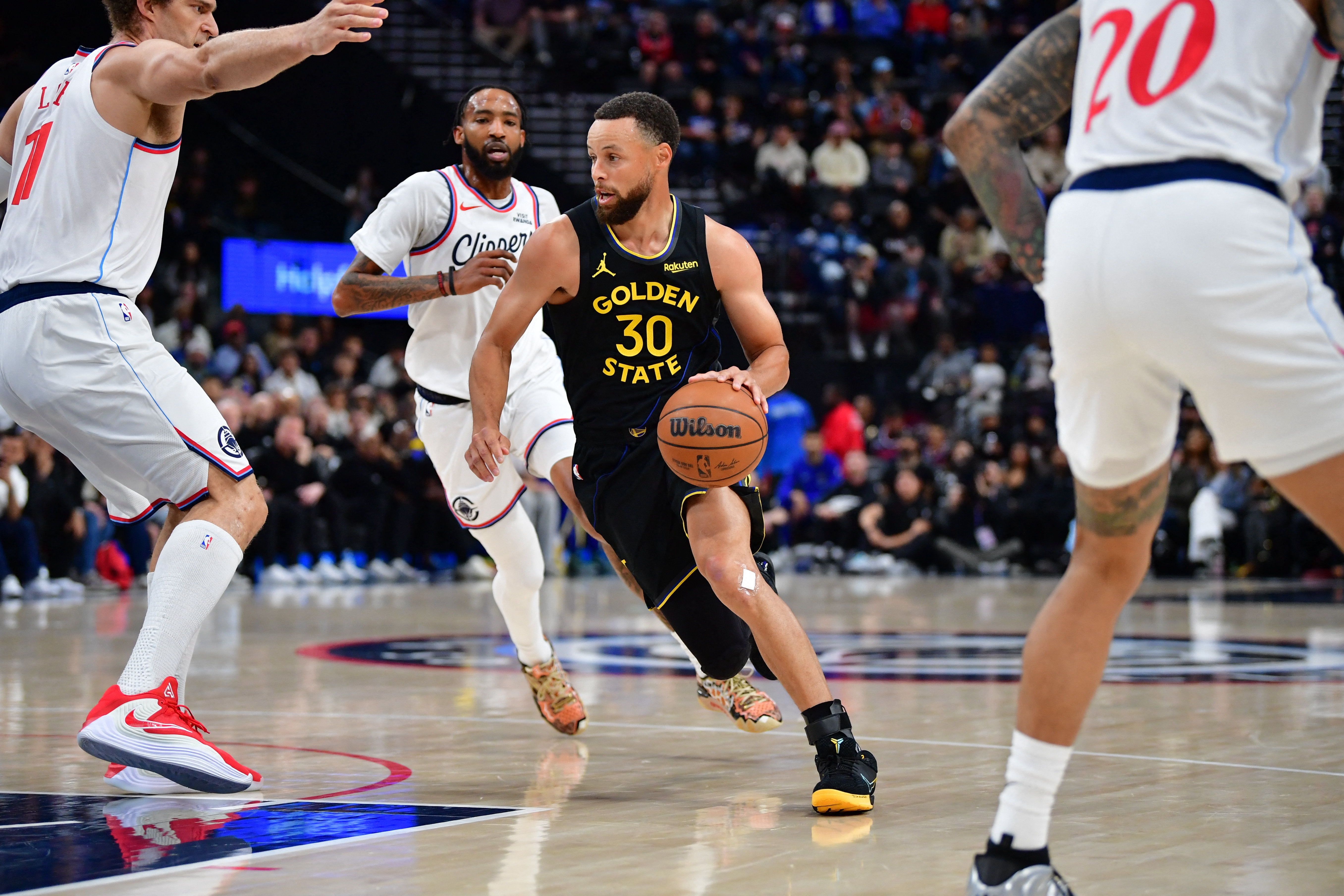 Golden State Warriors guard Stephen Curry (30) moves to the basket against Los Angeles Clippers defenders as we provide our Warriors vs. Clippers prediction.