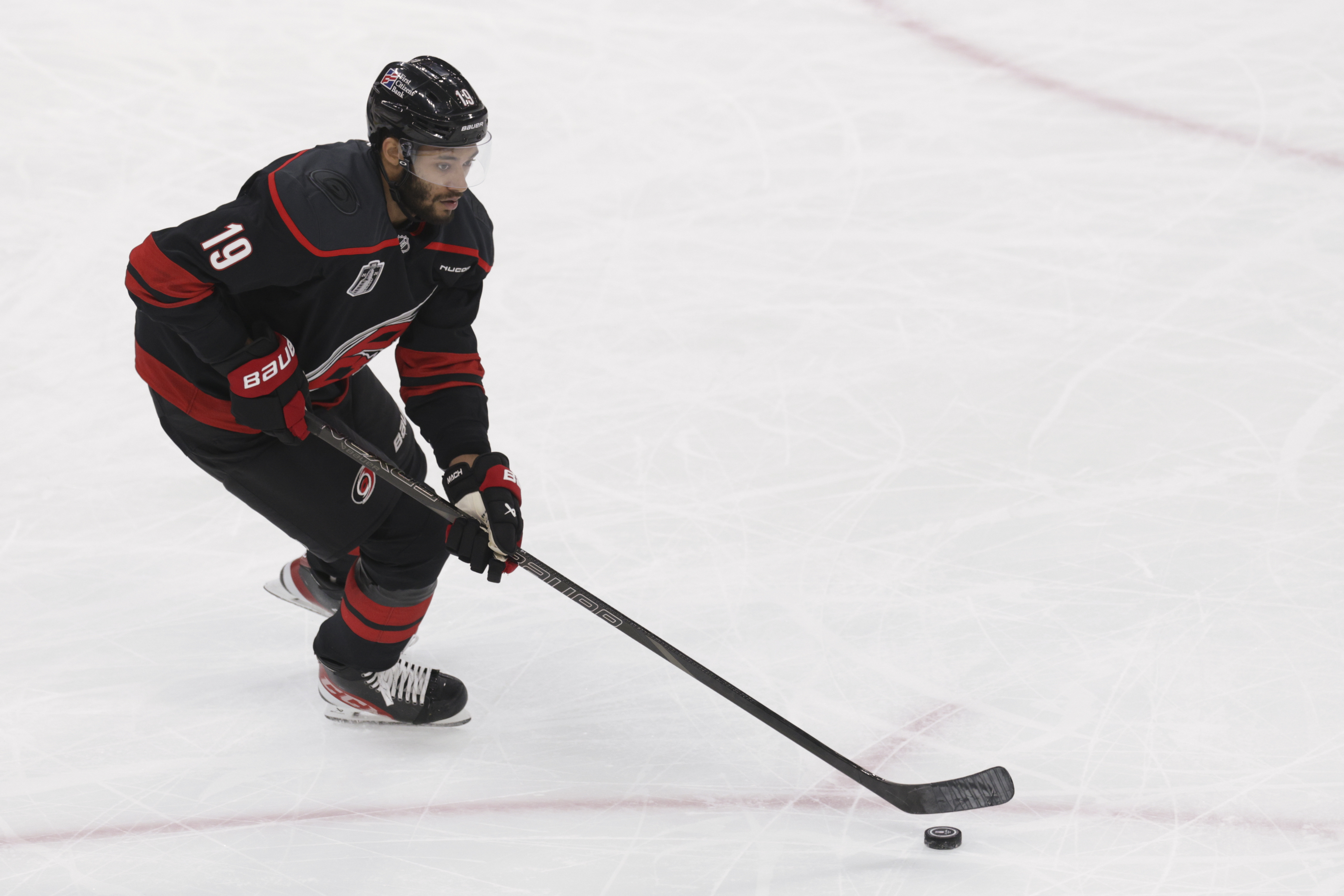 Carolina Hurricanes defenseman K'Andre Miller (19) skates with the puck as we provide our Golden Knights vs. Hurricanes prediction for Game 2.