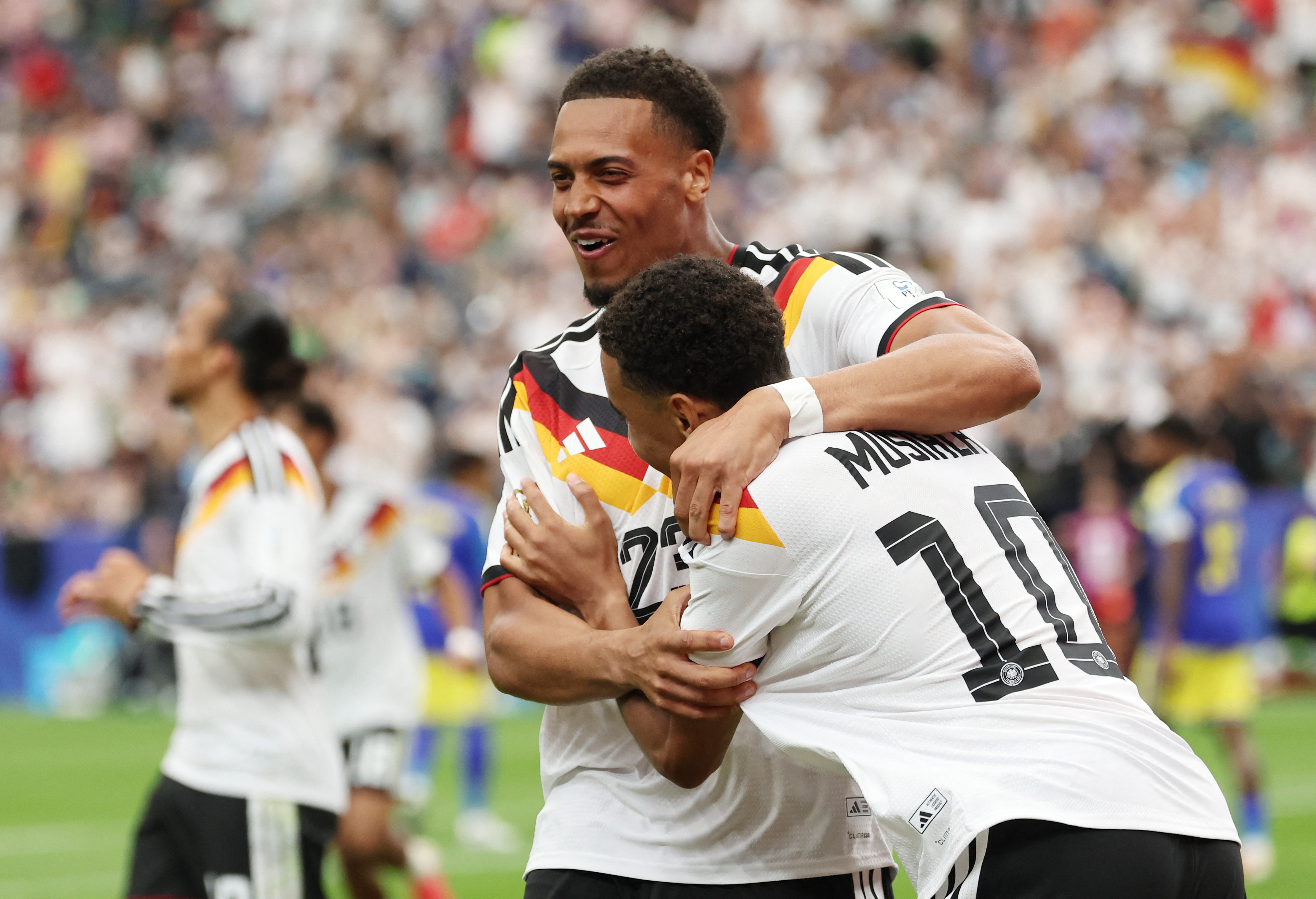 Germany's Jamal Musiala celebrates scoring with Felix Nmecha as we make our best Netherlands vs. Germany prediction.