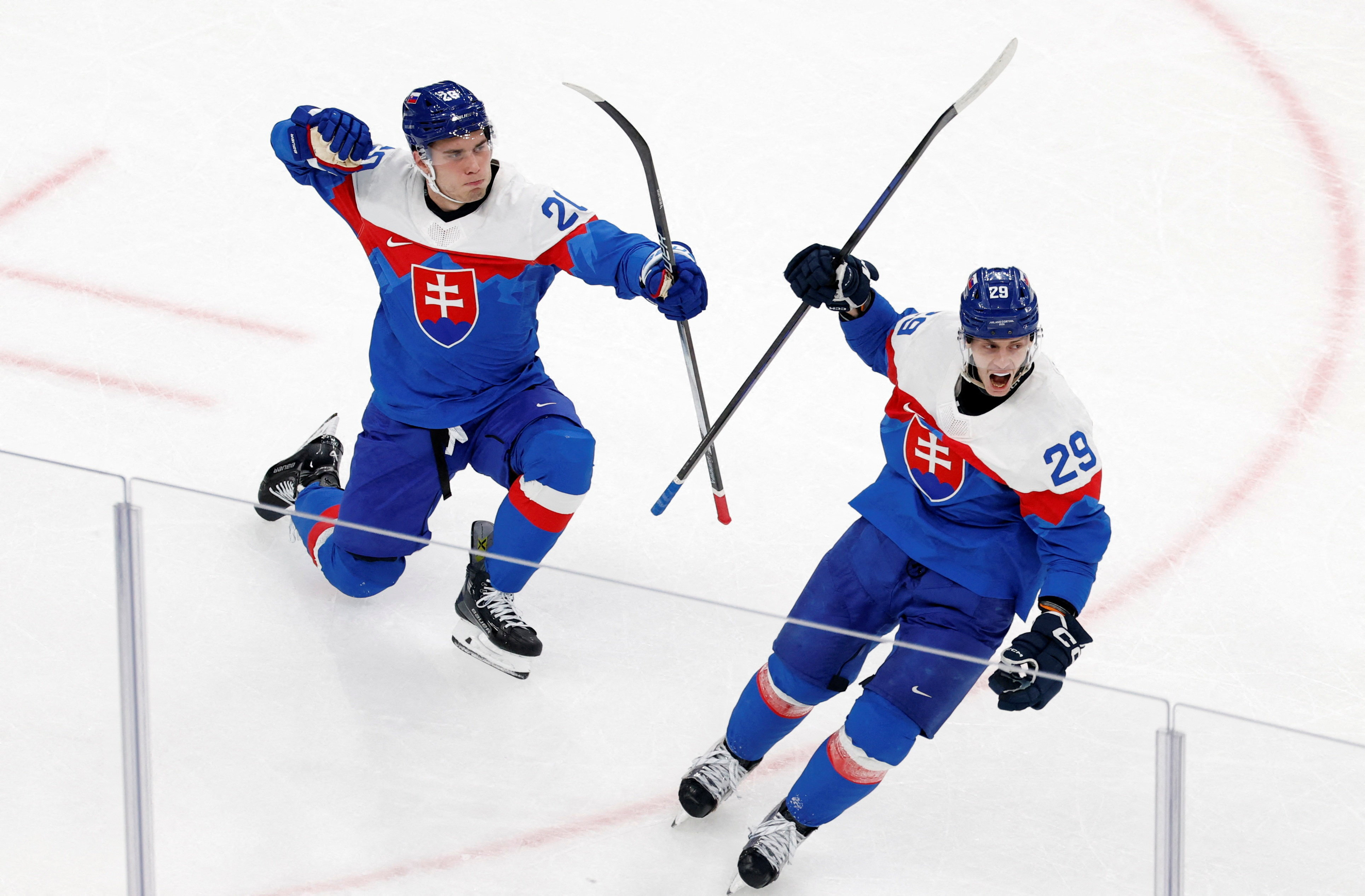 Slovakia's Juraj Slafkovsky and Michal Ivan celebrate a goal as we offer our Slovakia vs. Germany prediction.