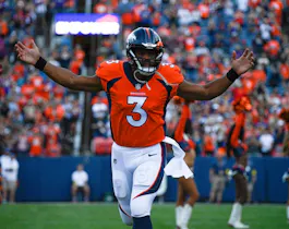 Quarterback Russell Wilson of the Denver Broncos runs onto the field before a preseason game against the Minnesota Vikings at Empower Field at Mile High on August 27, 2022 in Denver, Colorado.