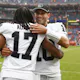 Jimmy Garoppolo #10 of the Las Vegas Raiders hugs Davante Adams #17 as we look at the best Sunday Night Football odds