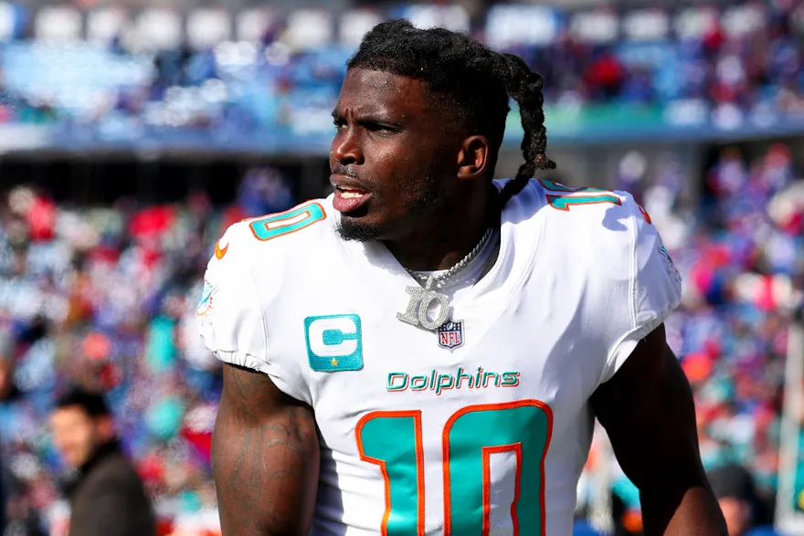 Tyreek Hill of the Miami Dolphins warms up prior to a game against the Buffalo Bills in the AFC wild-card playoff game, and we offer new U.S. bettors our exclusive Caesars promo code.