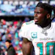 Tyreek Hill of the Miami Dolphins warms up prior to a game against the Buffalo Bills in the AFC wild-card playoff game, and we offer new U.S. bettors our exclusive Caesars promo code.