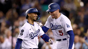 Mookie Betts of the Los Angeles Dodgers celebrates his solo home run with Freddie Freeman, and we look at the best start of season predictions based on the best MLB odds.