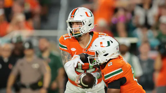 Miami Hurricanes quarterback Carson Beck (11) hands off the ball as we dive into our Stanford vs. Miami player prop bets for tonight.