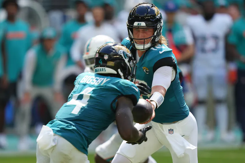 Jacksonville Jaguars quarterback Trevor Lawrence hands off to running back Tank Bigsby as we look at the Jaguars partnership with Hard Rock Bet.