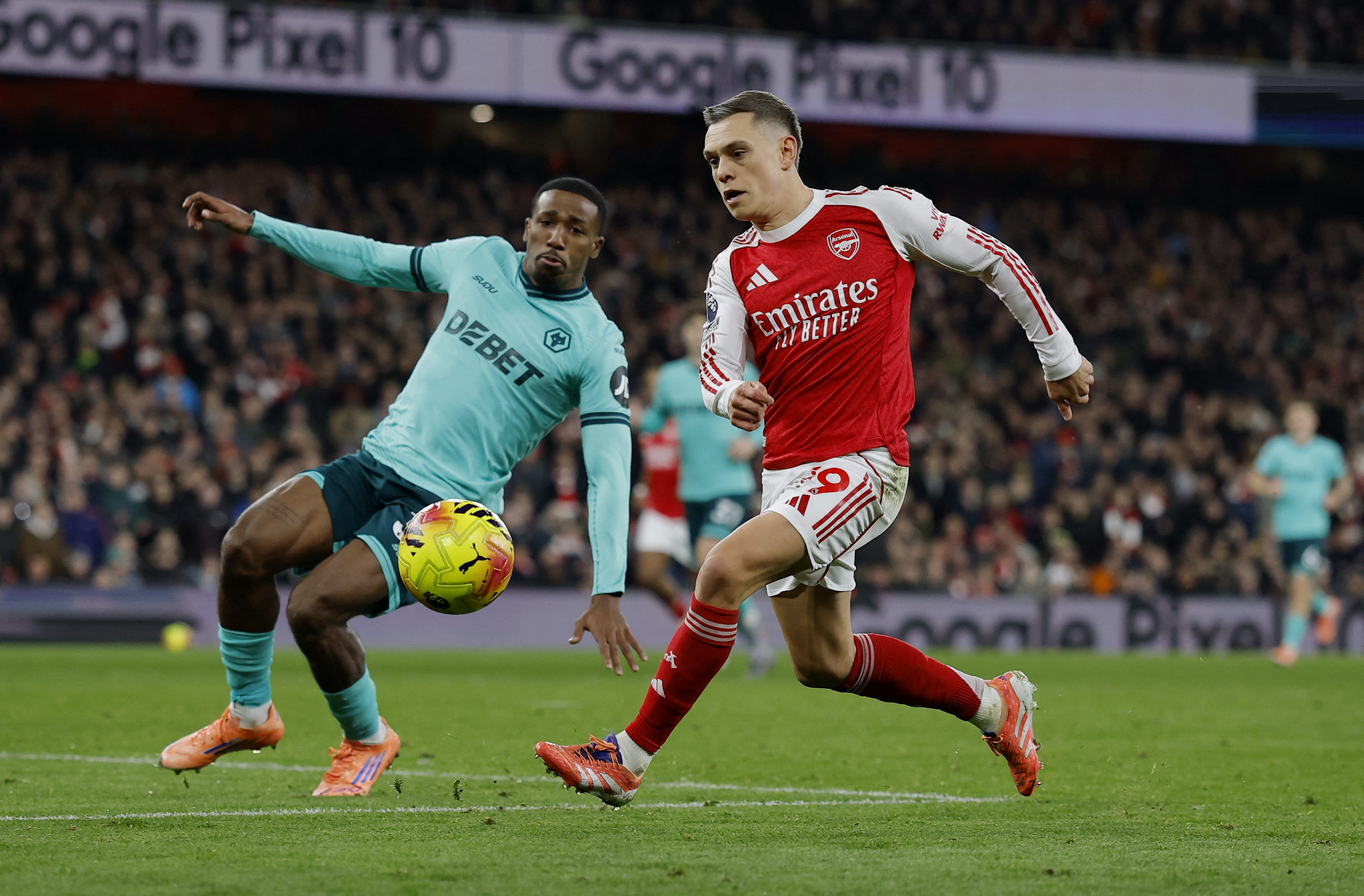 Wolves' Jackson Tchatchoua in action with Arsenal's Leandro Trossard as we make our best Wolves vs. Arsenal parlay picks and predictions. 