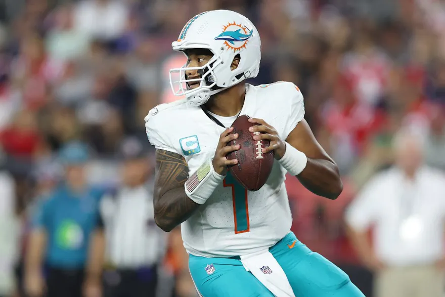 Tua Tagovailoa of the Miami Dolphins drops back to pass against the New England Patriots at Gillette Stadium, as we look at the most passing yards odds.