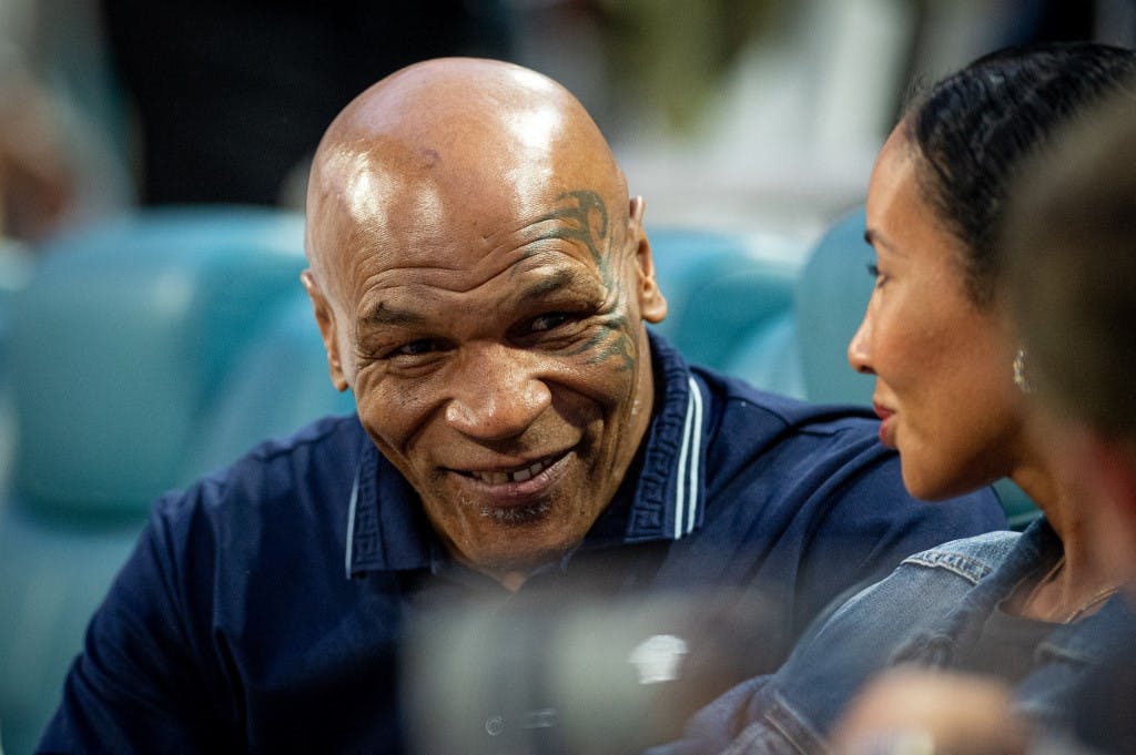 Mike Tyson watches the men