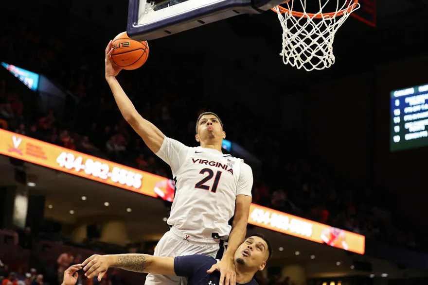 Kadin Shedrick of the Virginia Cavaliers shoots over Amaan Sandhu of the Monmouth Hawks in the second half during a game at John Paul Jones Arena on November 11, 2022 in Charlottesville, Virginia.