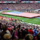 An American flag is displayed on the field as Reba McEntire sings the United States national anthem before Super Bowl LVIII in Las Vegas.