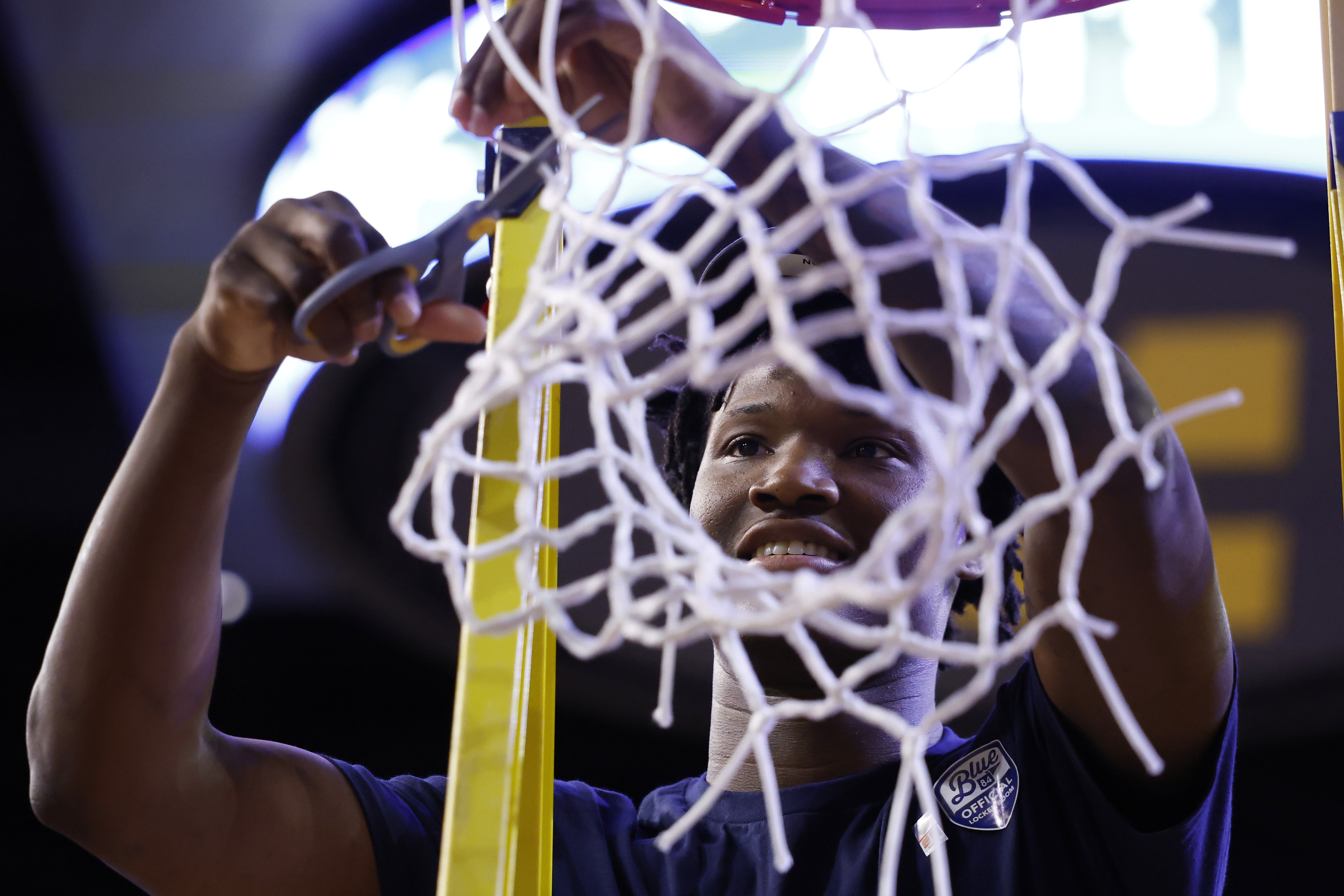 Michigan Wolverines guard L.J. Cason cuts down the net as we look at how big of a boost to sports betting March Madness provides.