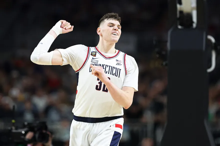 Donovan Clingan #32 of the Connecticut Huskies celebrates as we offer our best Purdue vs. UConn prediction and expert pick for the men's national championship game on Monday.