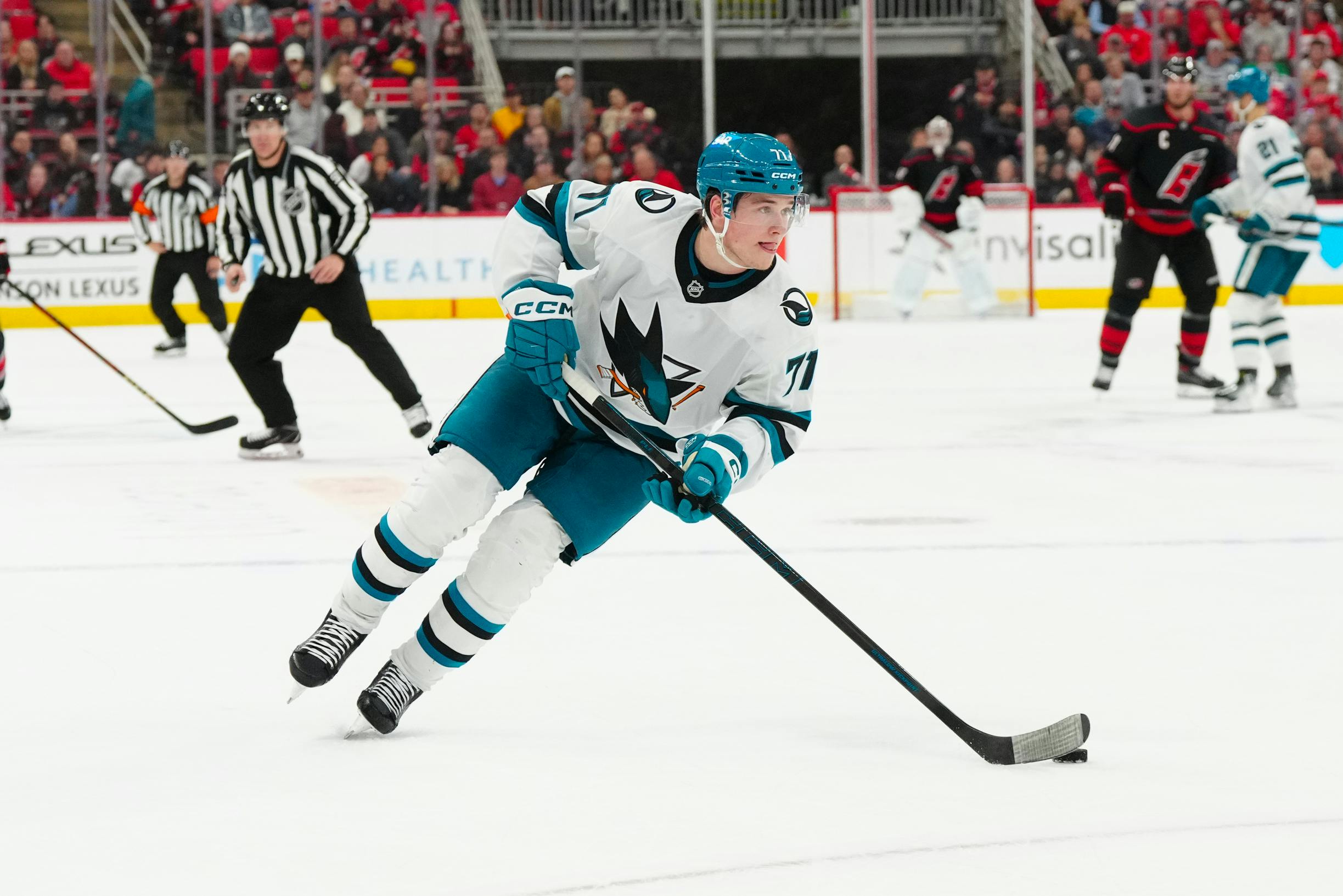 San Jose Sharks center Macklin Celebrini skates with the puck against the Carolina Hurricanes as we analyze the 2024-25 Calder Trophy odds. 