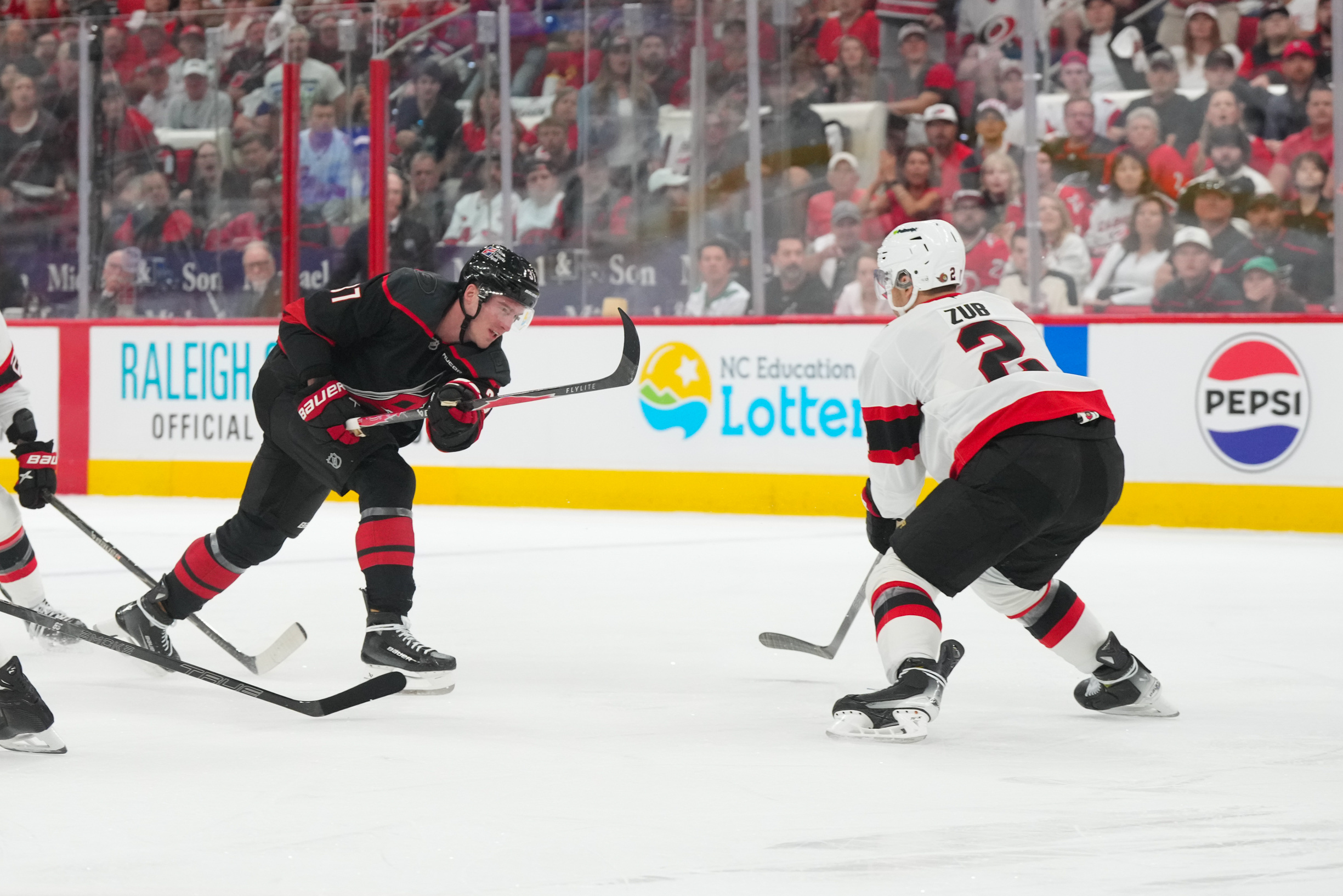 Carolina Hurricanes right wing Andrei Svechnikov gets a shot past Ottawa Senators defenseman Artem Zub as we make our best Senators vs. Hurricanes prediction.