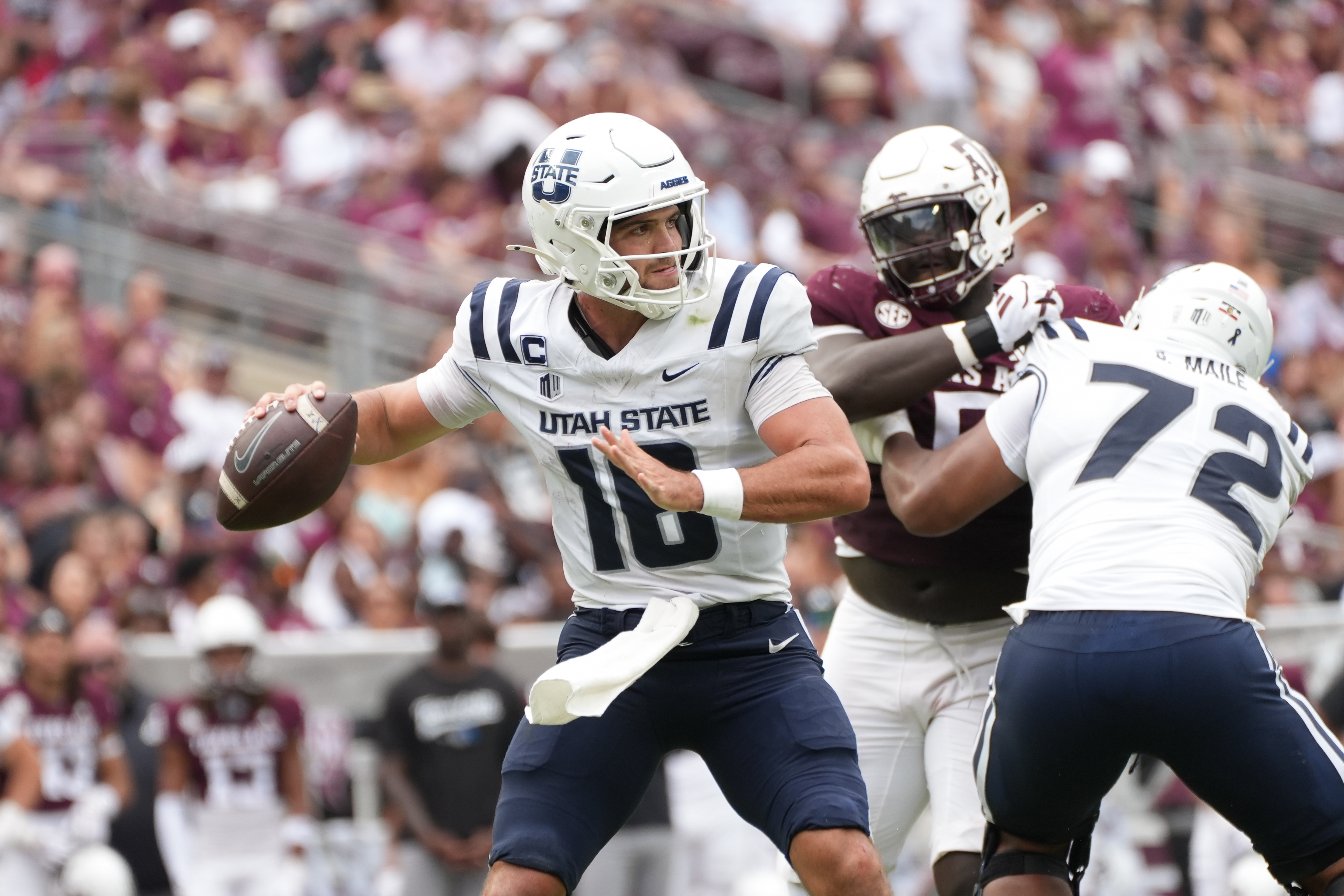 Utah State quarterback Bryson Barnes (16) throws the football as we offer our Washington State vs. Utah State predictions.