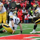 Quarterback Deacon Hill of the Iowa Hawkeyes trips handing off the ball as we share our best Michigan vs. Iowa prediction.
