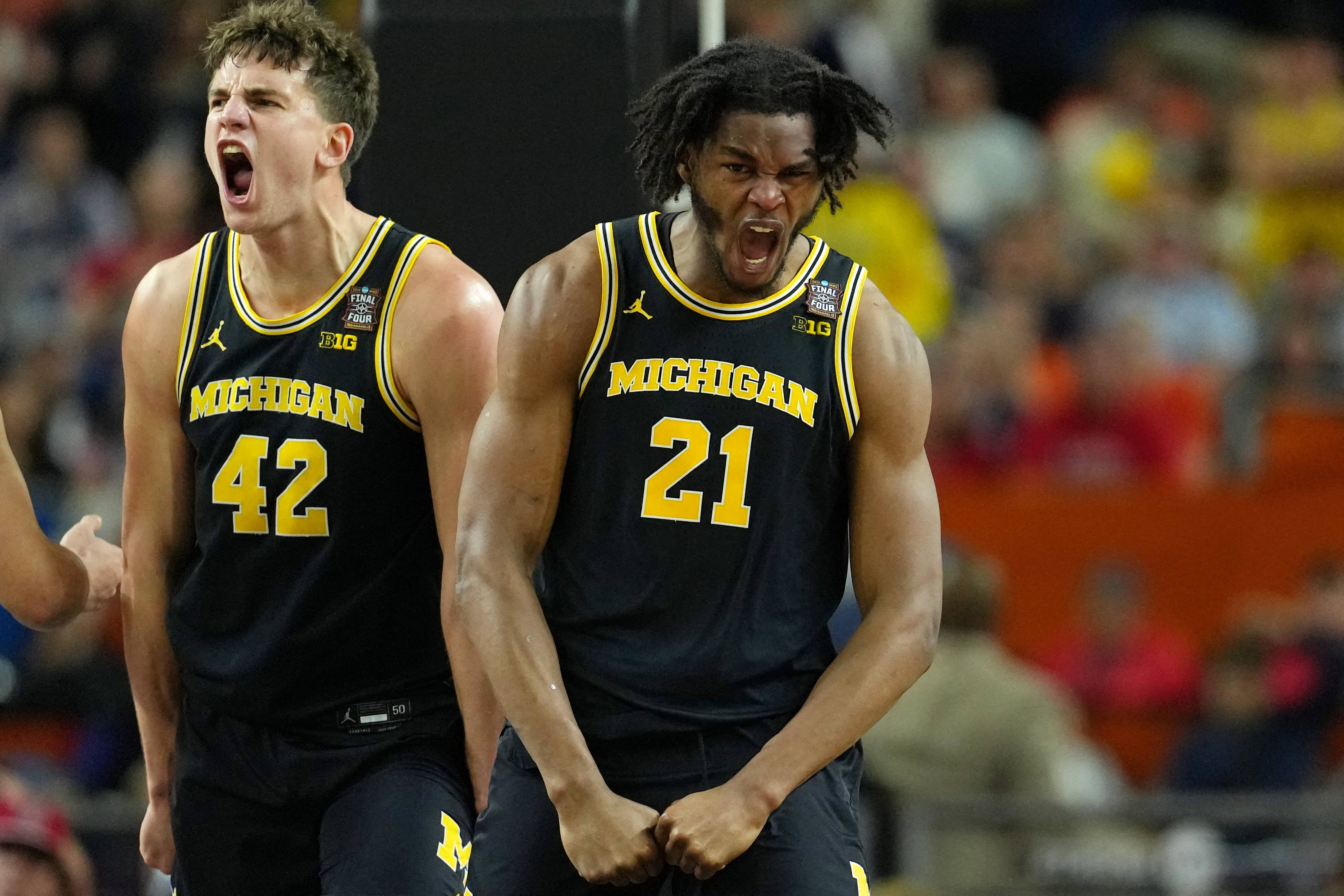 Michigan Wolverines forward Will Tschetter (left) and forward Morez Johnson Jr. (21) celebrate in the Final Four at Lucas Oil Stadium.