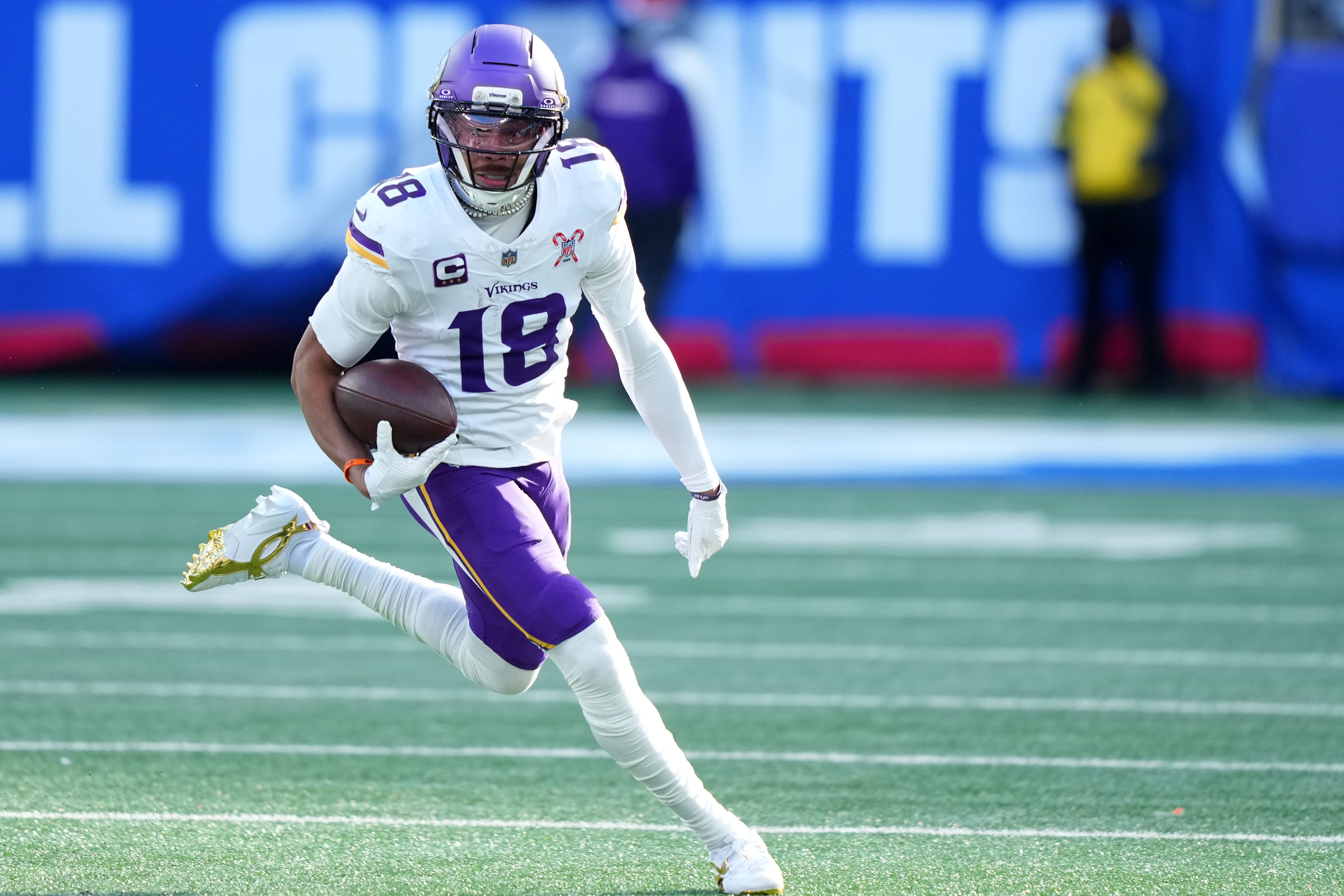 Minnesota Vikings wide receiver Justin Jefferson (18) runs with the ball as we offer Lions vs. Vikings predictions.
