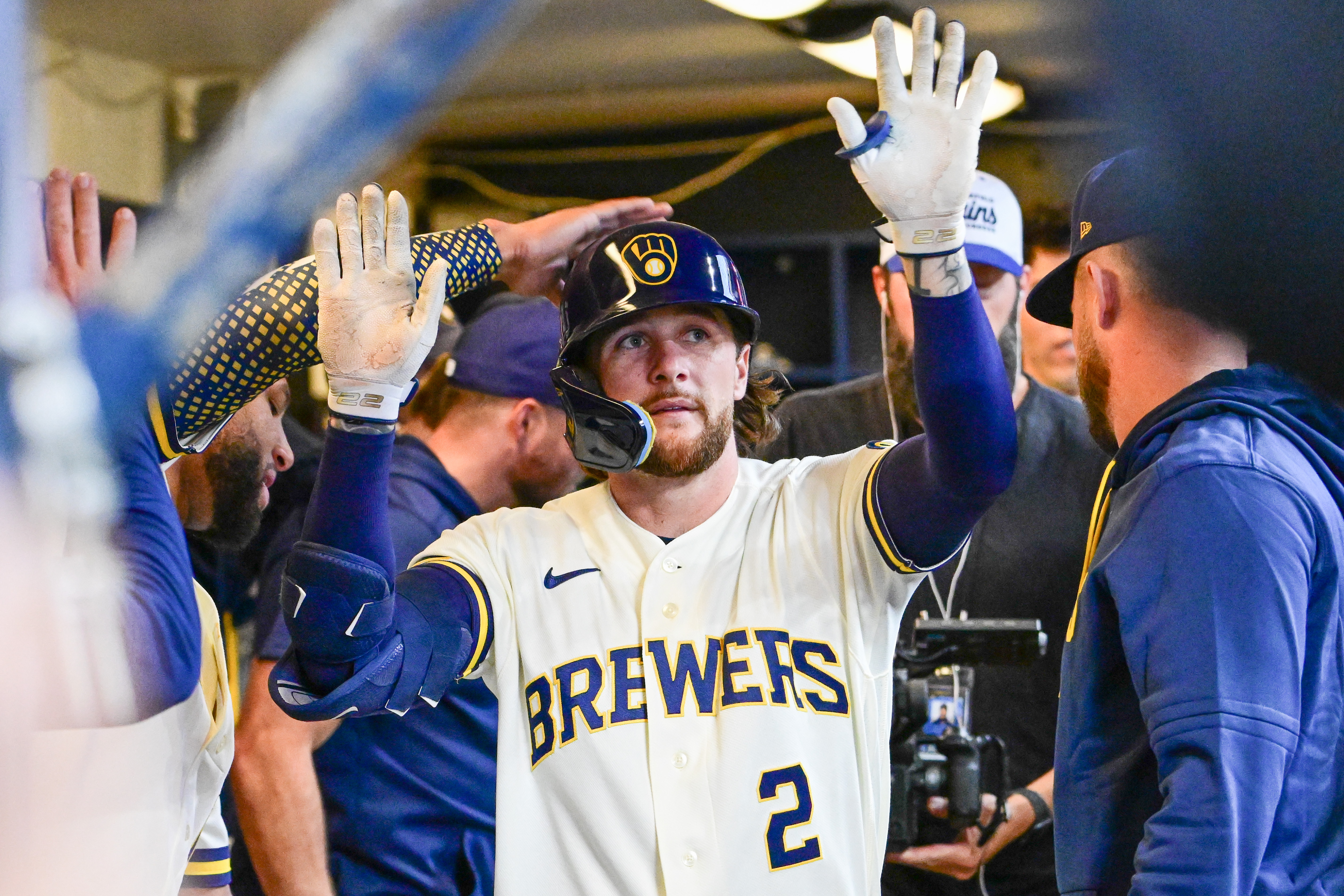 Milwaukee Brewers second baseman Brice Turang (2) is greeted in the dugout as he is featured in our Brewers vs. Braves prediction & picks.