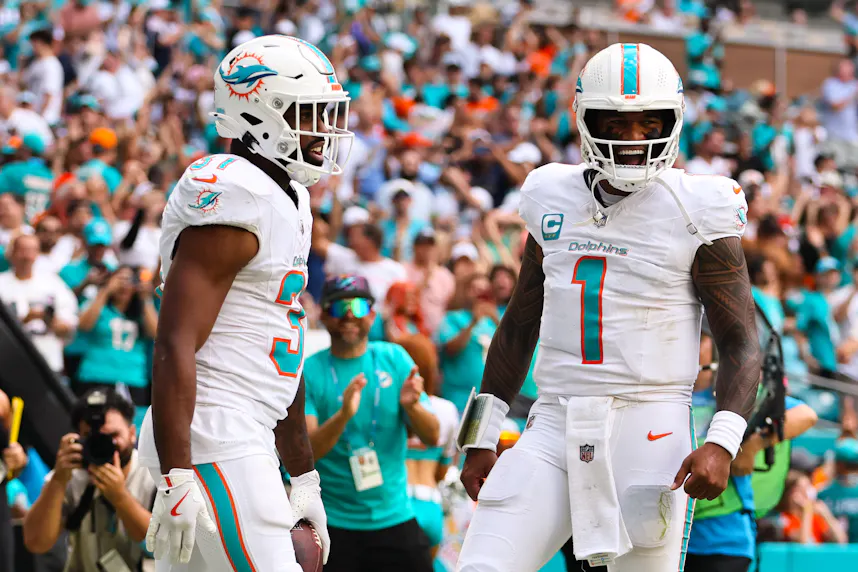 Miami Dolphins running back Raheem Mostert celebrates with quarterback Tua Tagovailoa after scoring a touchdown as we offer our Tagovailoa player props for the Dolphins' Week 9 game in Buffalo.