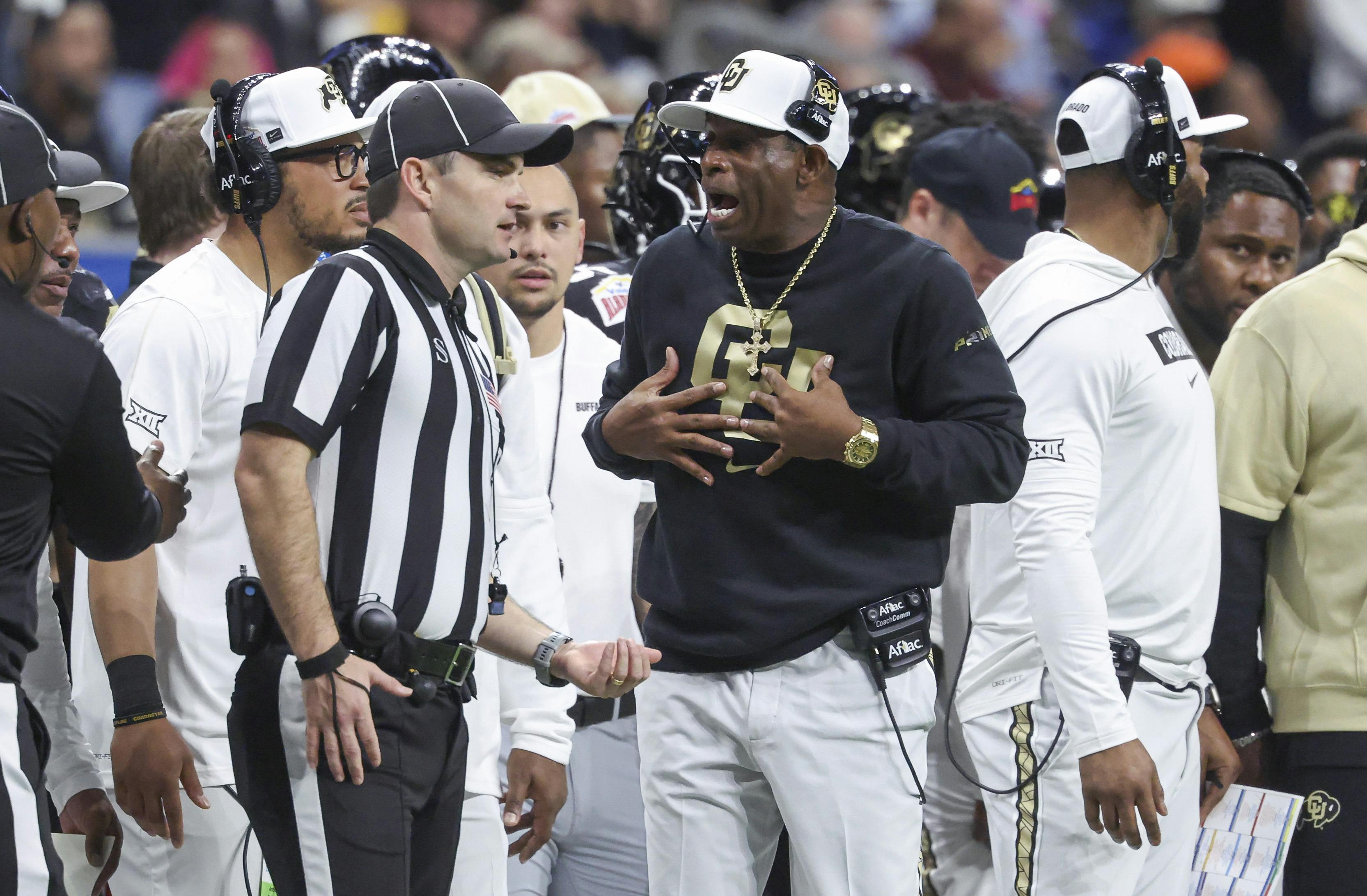 Colorado Buffaloes head coach Deion Sanders reacts with an official after a play as we look at the Cowboys next coach odds.