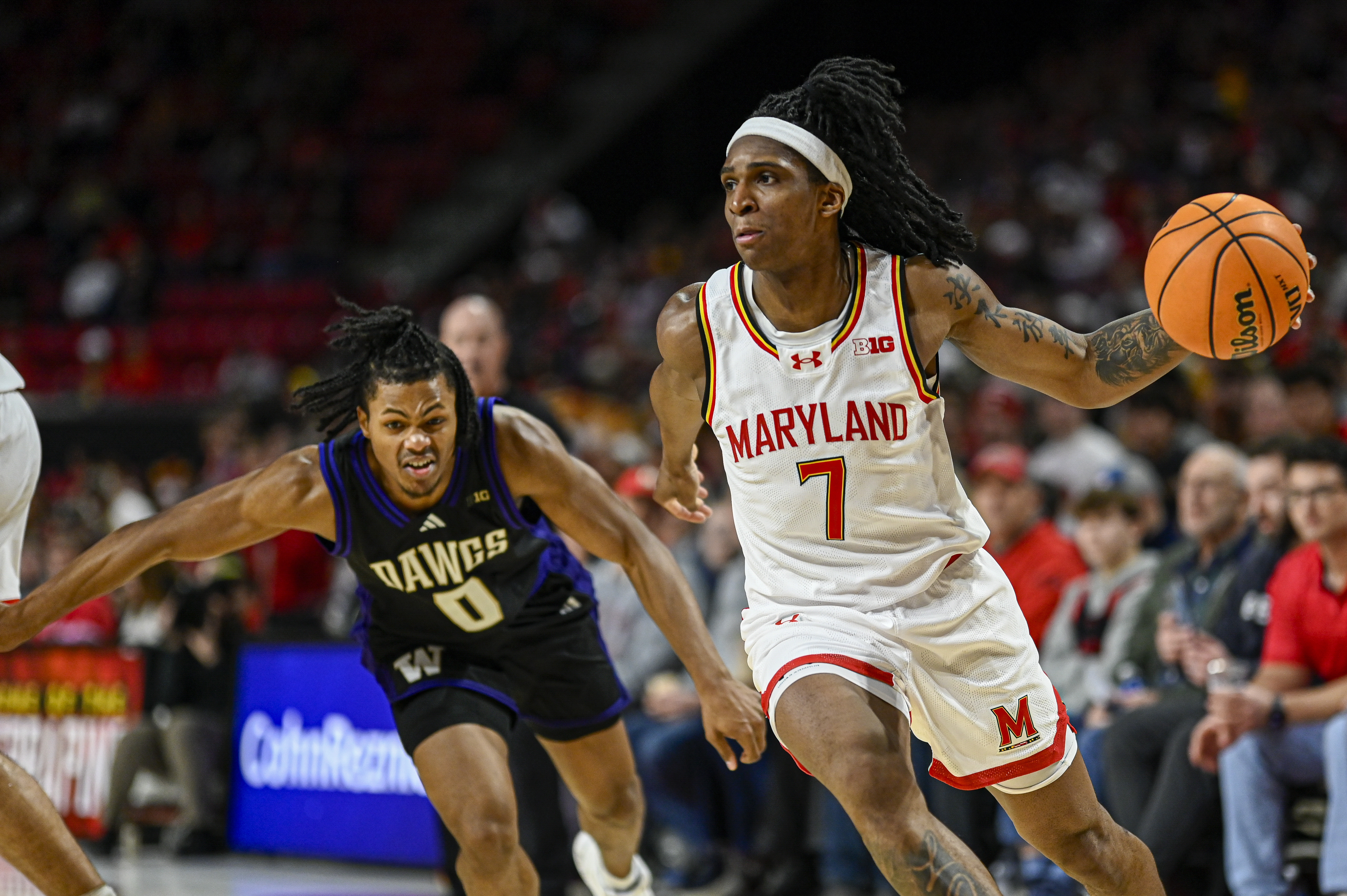 Andre Mills dribbles past Washington Huskies guard Quimari Peterson as we provide our Illinois vs. Maryland prediction and odds.
