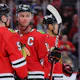 Connor Murphy #5 and Jonathan Toews #19 of the Chicago Blackhawks talk against the St. Louis Blues during the third period of a preseason game at United Center on September 27, 2022 in Chicago, Illinois.