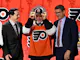 Philadelphia Flyers draft pick Matvei Michkov puts on his hat as we look at the 2025 NHL Calder Trophy odds