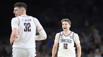 Cam Spencer #12 and Donovan Clingan #32 of the Connecticut Huskies celebrate as we offer our best last-minute national championship game picks for Purdue vs. UConn ahead of Monday's NCAA Tournament final.