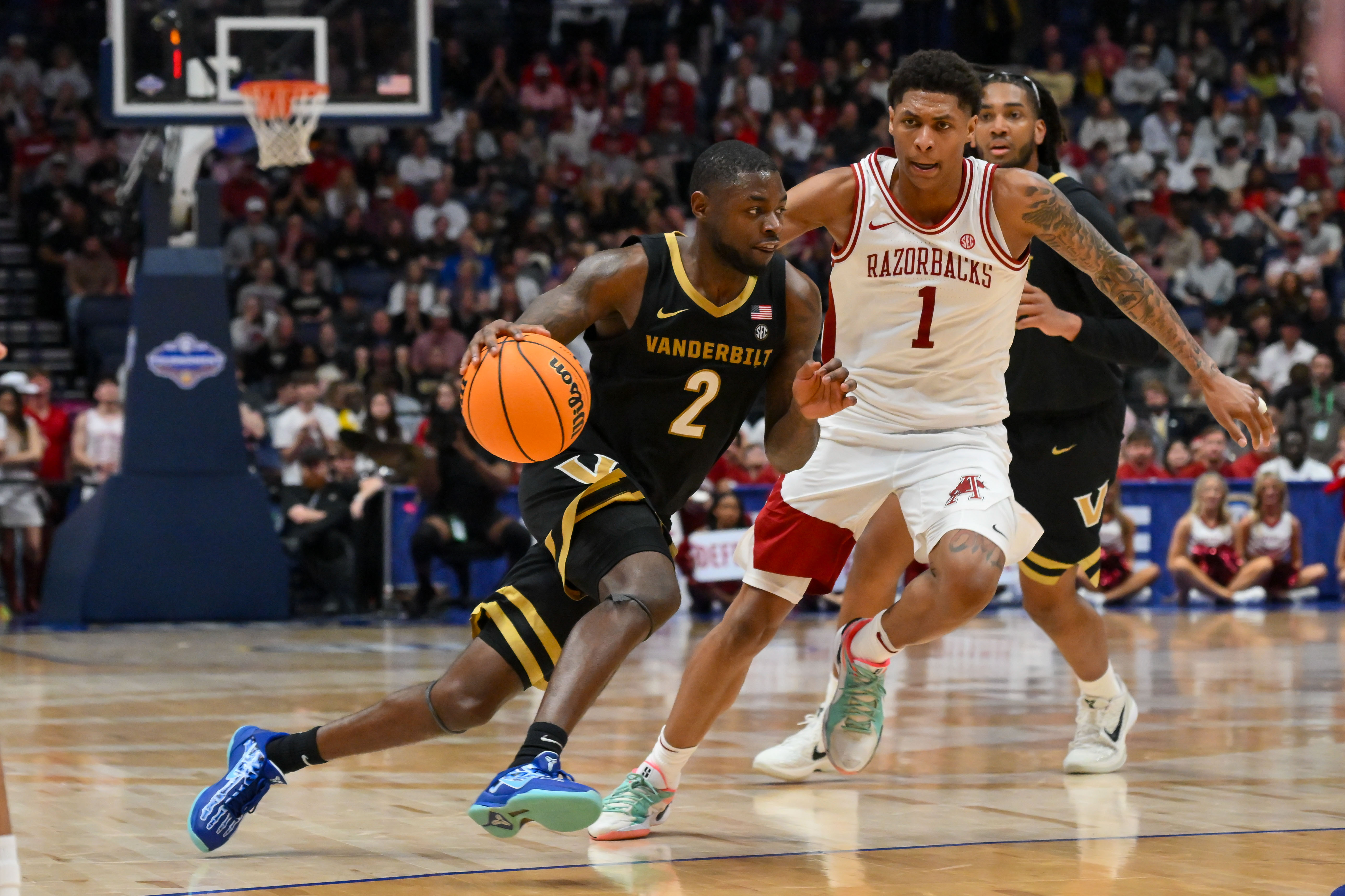 Vanderbilt Commodores guard Duke Miles (2) drives to the basket past Arkansas Razorbacks guard Meleek Thomas (1) in the SEC Tournament.
