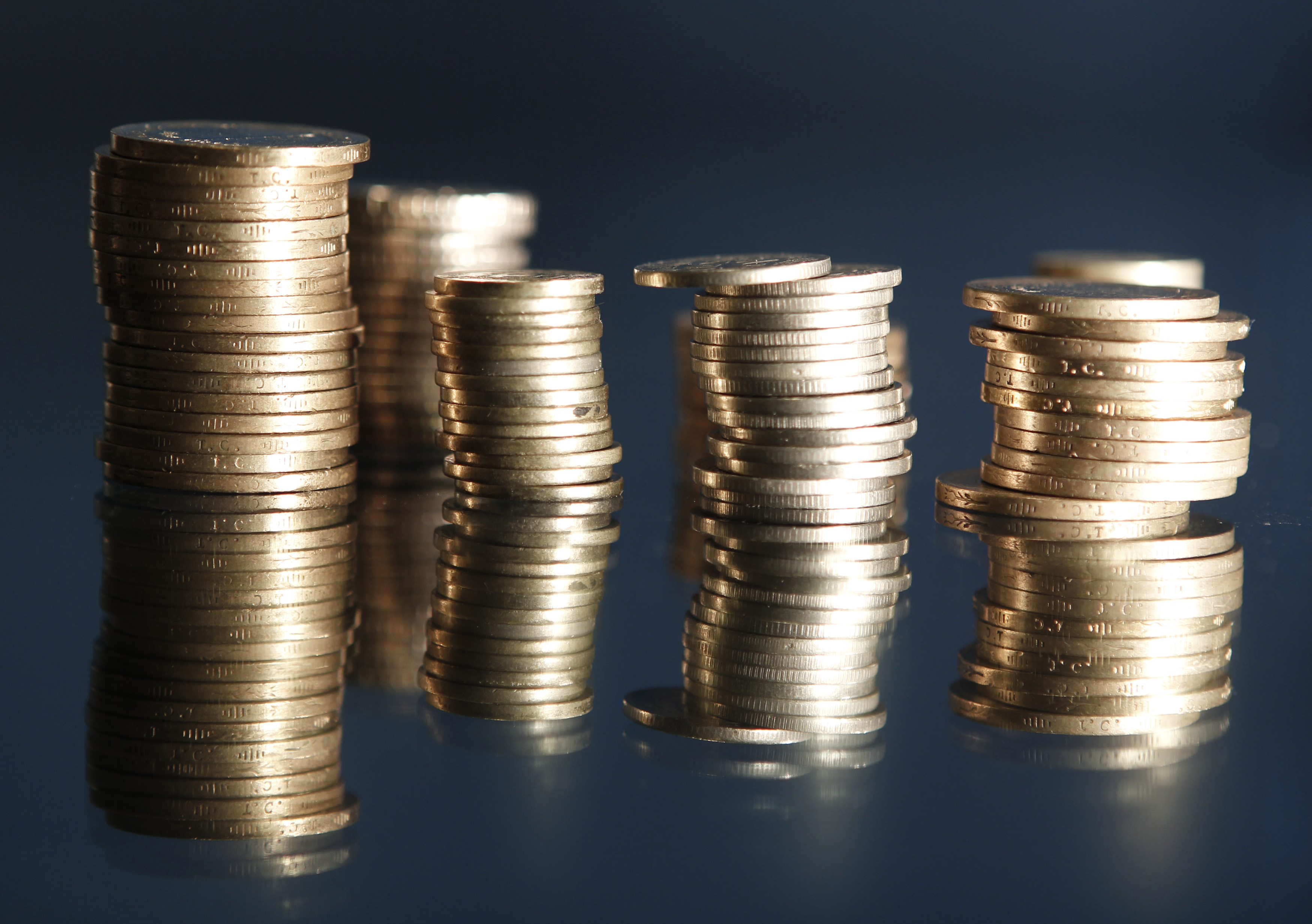 Stacks of coins are seen as we look at Michael Burry buying into DraftKings and Flutter.