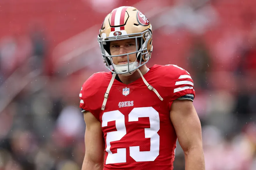 Christian McCaffrey of the San Francisco 49ers looks on prior to the NFC Wild Card playoff game against the Seattle Seahawks, and we offer our top first touchdown scorer predictions for Week 13 based on the best NFL odds.