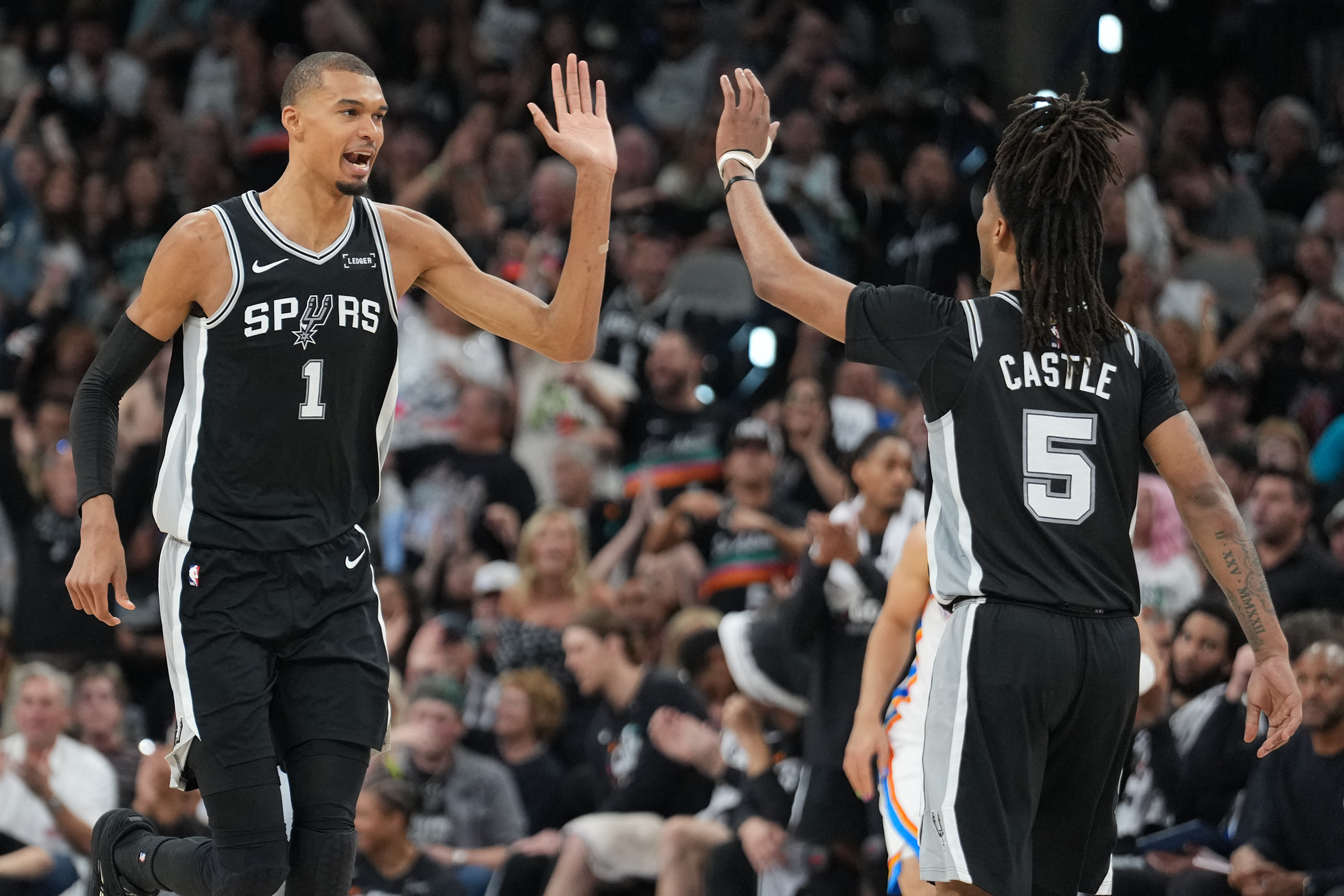 San Antonio Spurs forward Victor Wembanyama (1) reacts with guard Stephon Castle (5) in Game 6 of the Western Conference Finals for the 2026 NBA playoffs.