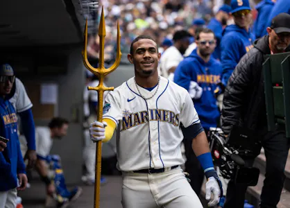 Julio Rodriguez of the Seattle Mariners poses with a trident in the dugout after hitting a solo home run against the Houston Astros, and we offer our top MLB player props and expert picks based on the best MLB odds.