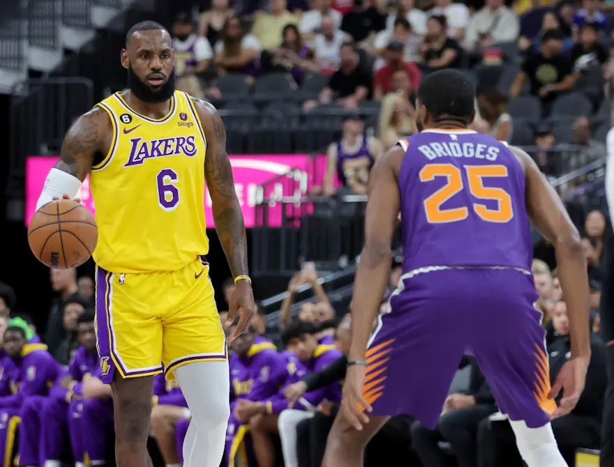 LeBron James #6 of the Los Angeles Lakers brings the ball up the court against the Mikal Bridges #25 of the Phoenix Suns in the first quarter of their preseason game at T-Mobile Arena on October 05, 2022 in Las Vegas, Nevada.