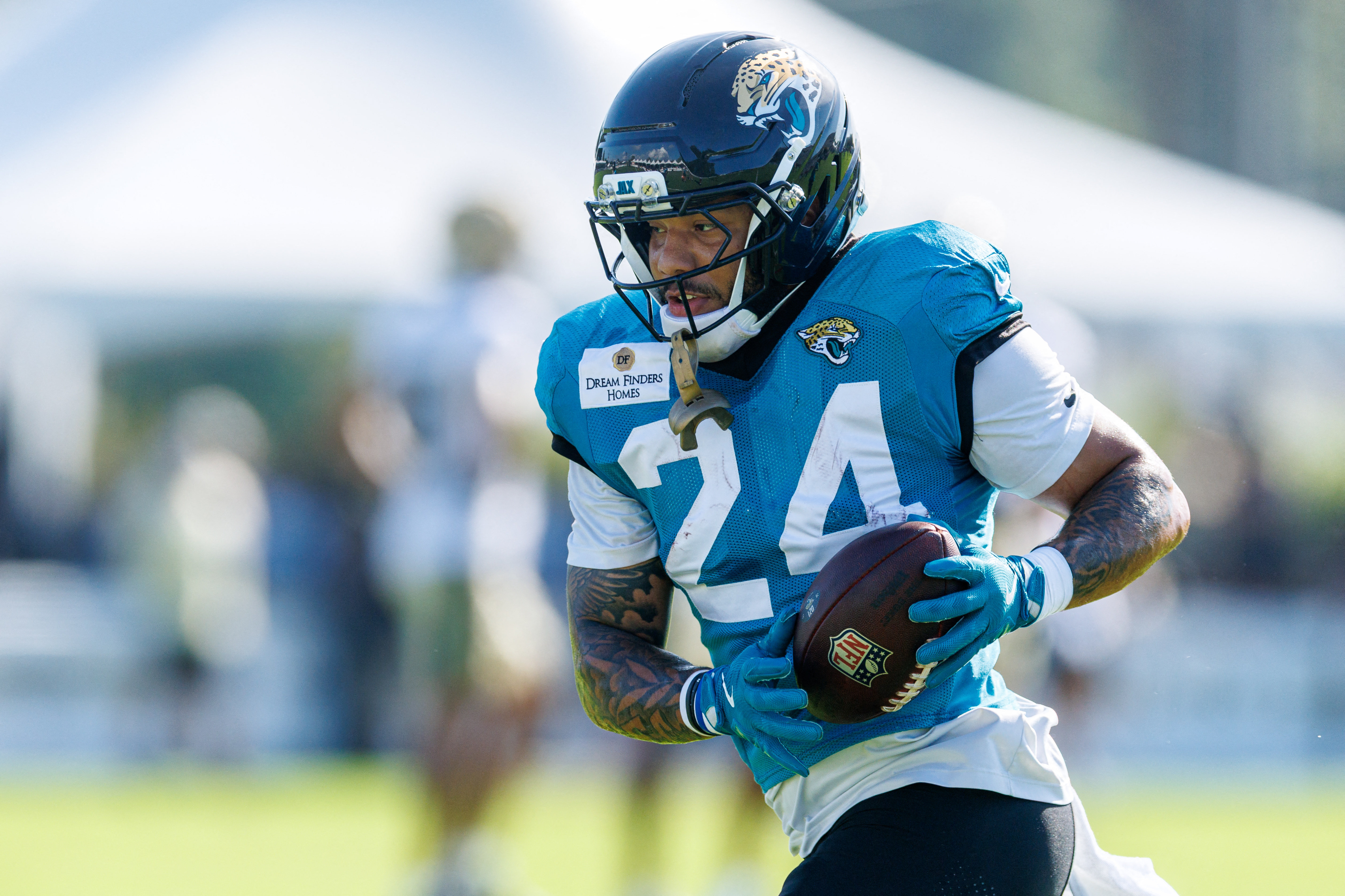 Jacksonville Jaguars running back Chris Rodriguez Jr. (24) runs as we break down our Browns vs. Jaguars prediction.