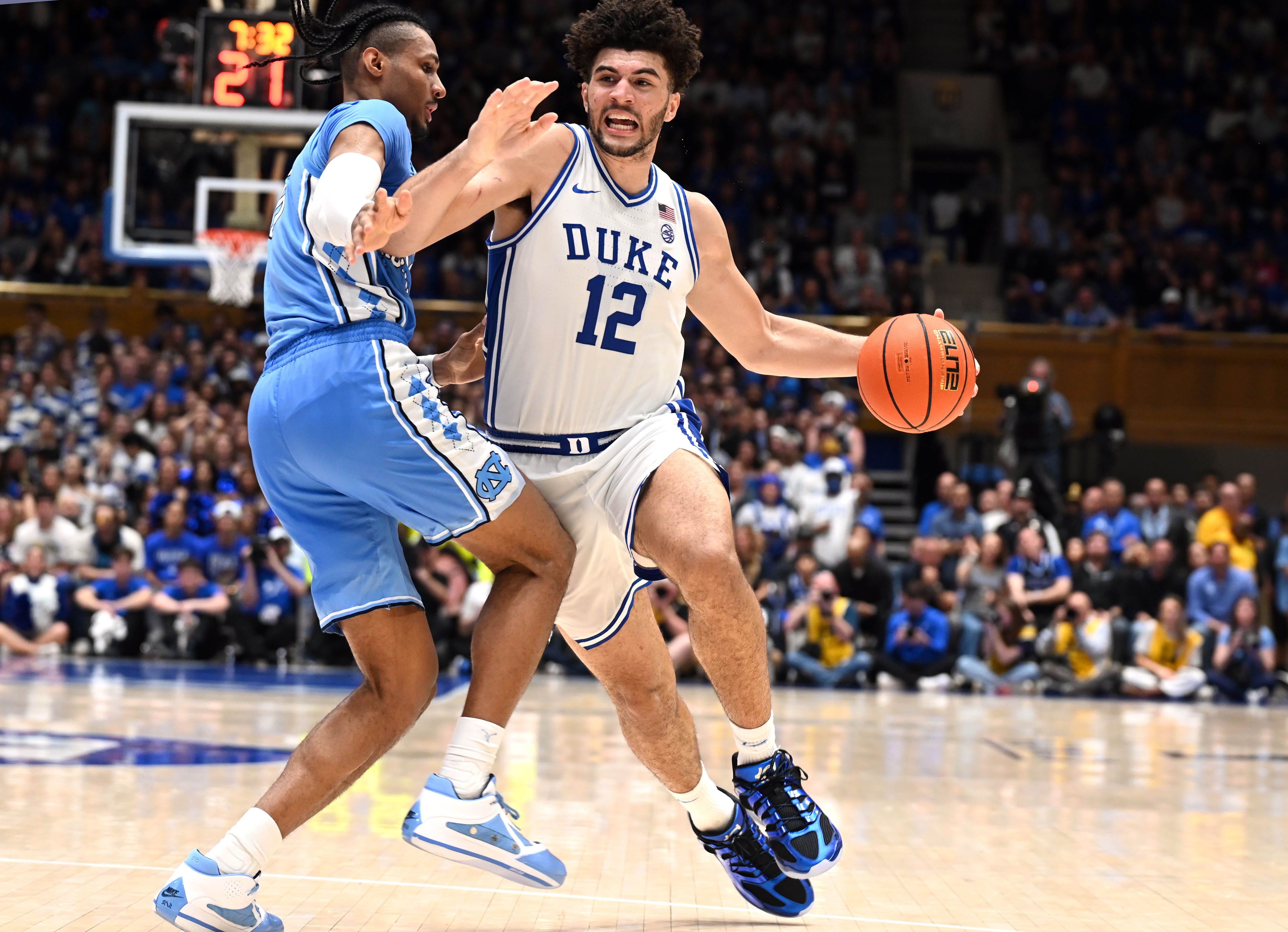 Duke Blue Devils forward Cameron Boozer (12) drives to the basket as North Carolina Tar Heels forward Jarin Stevenson (15) defends.