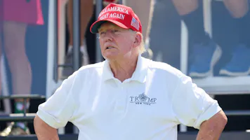 Former President Donald Trump looks on at the first hole prior to the start of Day 3 of the LIV Golf Invitational - Bedminster at Trump National Golf Club as we look at our 2024 U.S. presidential election odds.
