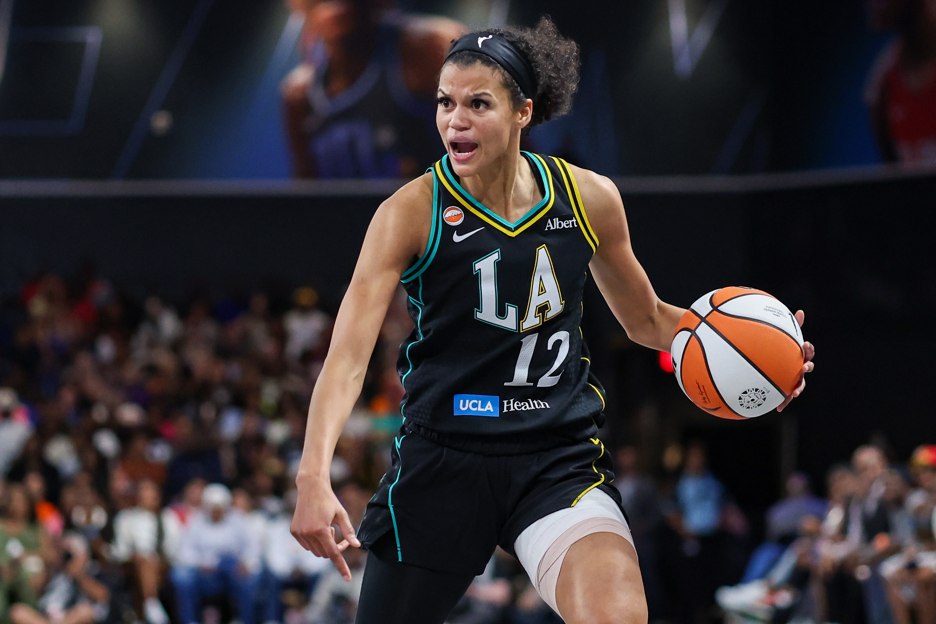 Los Angeles Sparks guard Rae Burrell (12) dribbles as we break down our Sparks vs. Sky prediction.