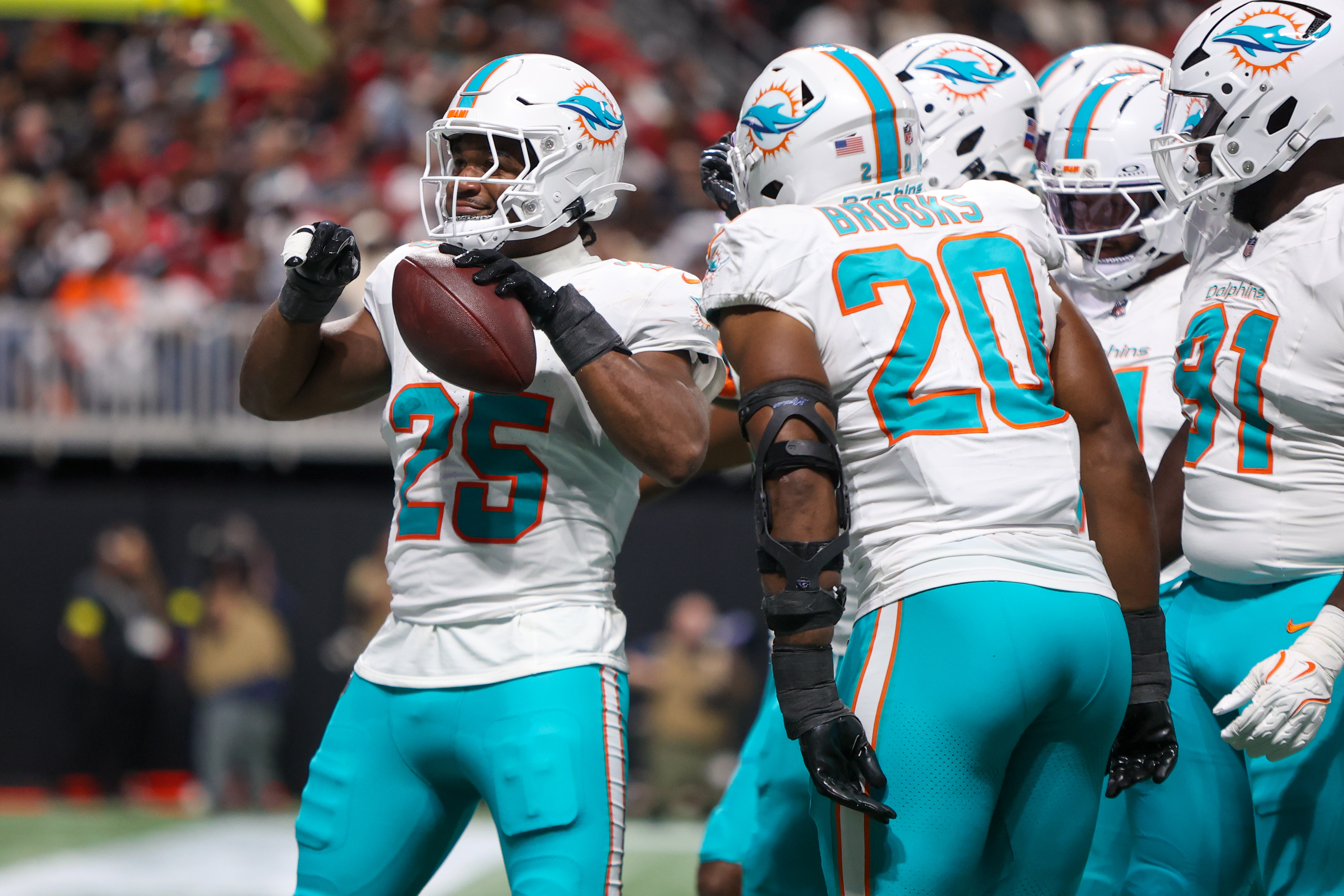 Miami Dolphins linebacker Tyrel Dodson celebrates with teammates after a fumble recovery as we look at the latest Week 9 NFL odds