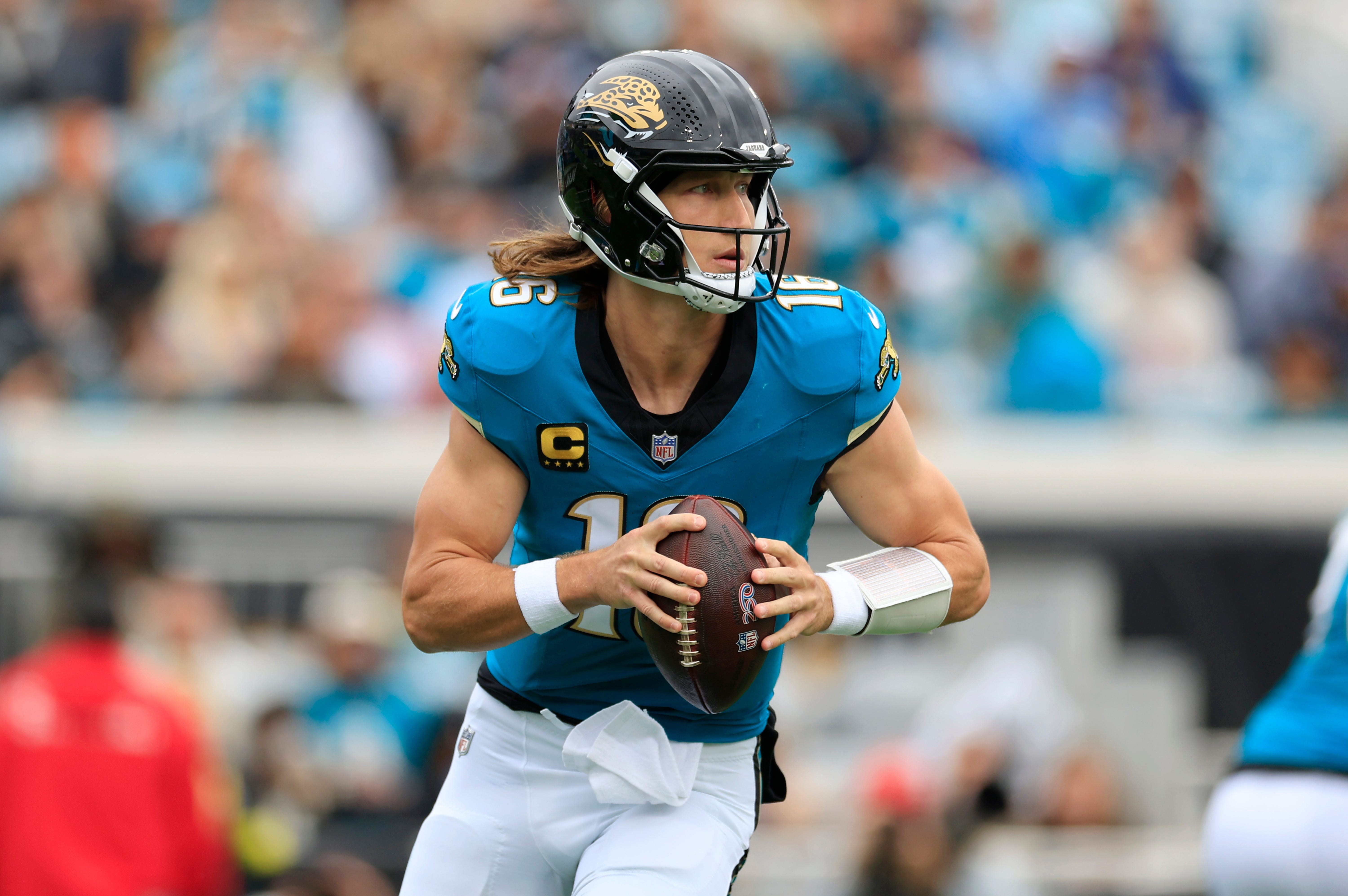 Jacksonville Jaguars quarterback Trevor Lawrence (16) looks to throw as we offer our Bills vs. Jaguars predictions.