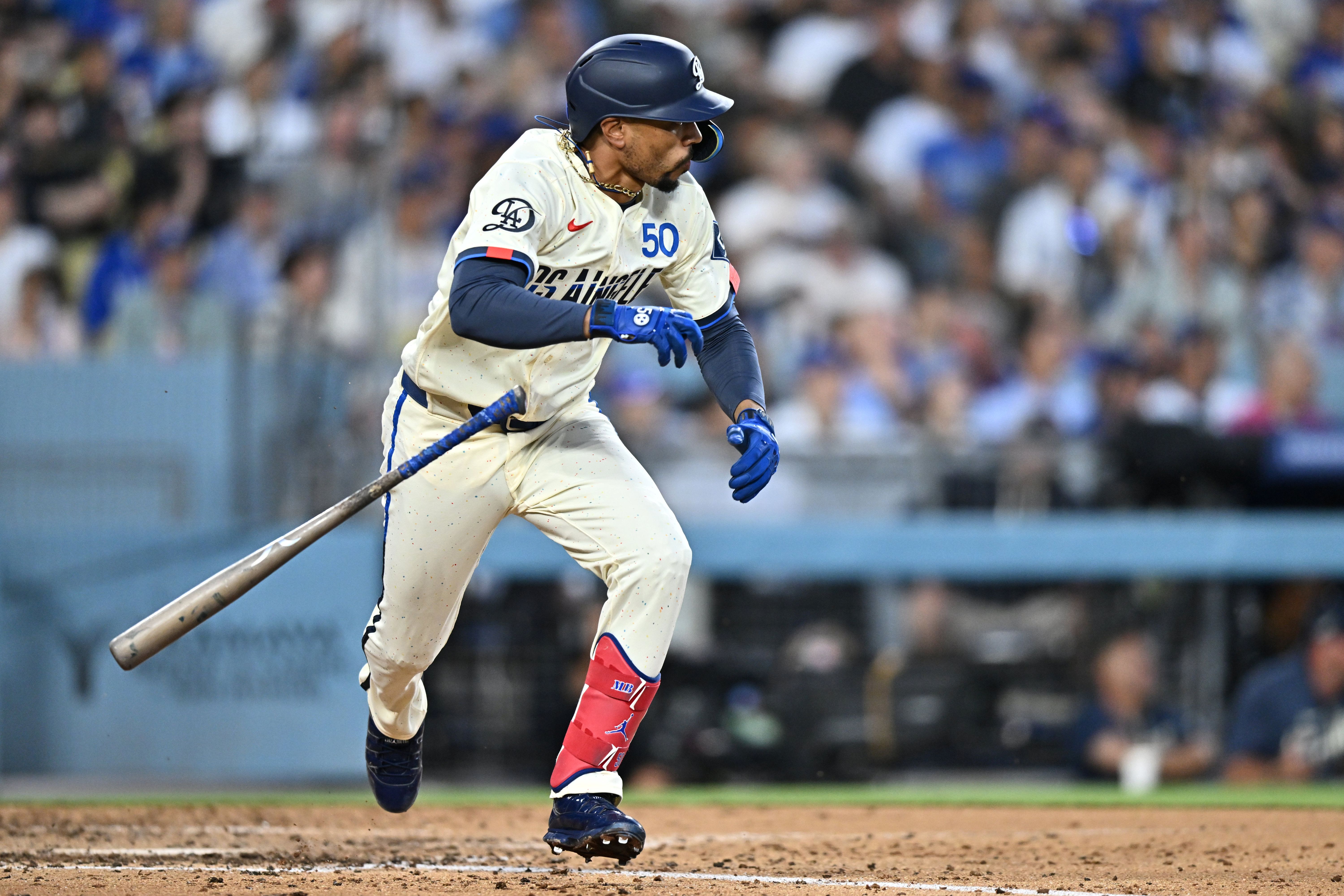 Los Angeles Dodgers shortstop Mookie Betts runs after hitting an RBI single while we make our best Diamondbacks vs. Dodgers prediction.
