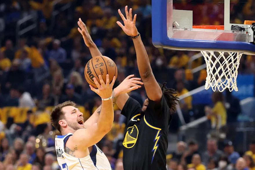 Luka Doncic of the Dallas Mavericks drives to the basket against Kevon Looney of the Golden State Warriors in Game Five of the 2022 NBA Playoffs Western Conference Finals at Chase Center on May 26, 2022 in San Francisco, California
